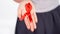 Woman palm showing world AIDS day ribbon