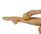 Woman pampring her leg with sponge