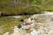 A woman panning for gold at spruce creek, bc