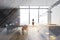 Woman in panoramic gray kitchen with table