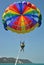 Woman parasailing over aqua water