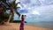 Woman in pareo taking picture of exotic beach with