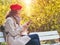 Woman on a park bench chatting on smartphone