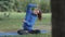 a woman in the park is stretching on a blue yoga mat. jogging and warming up in a public place, a European millennial