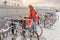 Woman parking her bicycle on the street in old town