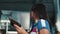 Woman passenger checking flight time at arrival departure board holding documents and ticket pass