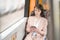 woman passenger sitting with smartphone while moving in separate trams enjoying public transport ride