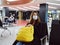 woman passenger yellow backpack airport waiting medical mask