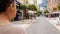 Woman passing by restaurants and tourist shops, walking around European city