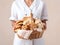 woman pastry chef holds a basket with various delicious cookies