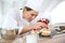 Woman pastry chef preparing desert