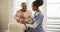 Woman, patient and caregiver by holding hands in nursing home for assistance with mobility in wheelchair. Black people