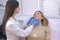 Woman patient is consulted by a cosmetologist before injections into the face.