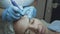 Woman patient at the cosmetologist dermatologist doctor. Smoothes forehead wrinkles with cryoplasma and argon