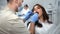 Woman patient with open mouth at regular dental medical checkup at clinic