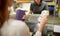 Woman paying money at store cash register