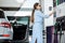 Woman paying with phone at the gas station