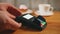 A woman pays coffee and dessert with a bank card, a contactless payment method