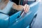 A woman pays with a credit card while refueling a car