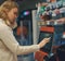 Woman pays at self-checkouts