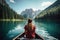 A woman peacefully sits in a boat on a calm and scenic lake, taking in the tranquility of nature, Beautiful woman kayaking on a