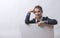 Woman peeking over edge of blank empty paper billboard with copy space for text