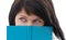 Woman peeking over edge of book