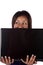 Woman peeking over laptop