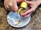 Woman peel potato with peeler over kitchen table