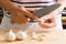 Woman peeling garlic by knife