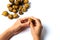 Woman peeling langsat tropical fruit on white background