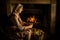 Woman peeling potatoes at fireplace