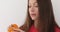 Woman peeling ripe sweet tangerine close up