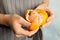 Woman peeling ripe tangerine, closeup.