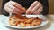 A woman peels boiled shrimps, closeup. Focus on the hands