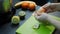 Woman peels mandarin. Female hands peel mandarin on kitchen, fresh fruit on background. Woman preparing fruit smoothie. Organic he