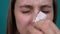 Woman peels off white mask on her nose against black dots on the skin