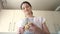 Woman peels potatoes at kitchen