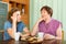 Woman pensioner having conversation with her daughter