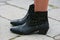 Woman with Pepe Jeans black leather bootie before Gucci fashion show, Milan Fashion Week street style on