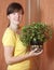 Woman with Peperomia obtusifolia in pot