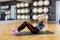 Woman Performing Crunches On Exercise Mat In Gym