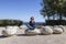 Woman performing joga on energy stones near sea coast