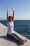 Woman performing joga on sea coast