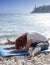 Woman performing joga on sea coast