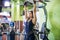 Woman performing pull ups in a bar at gym.