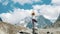 Woman performs an basic asana tree - vriksasana in yoga on a background of a snowy mountain in a hike. Girl does