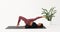 A woman performs leg rolls with a yoga brick, the exercise is aimed at mastering the longitudinal splits