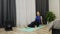 Woman performs myofascial release with fitness roller. Young caucasian brunette does restorative and relaxing massage on yoga mat
