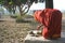 Woman performs traditional morning worship ritual in courtyard